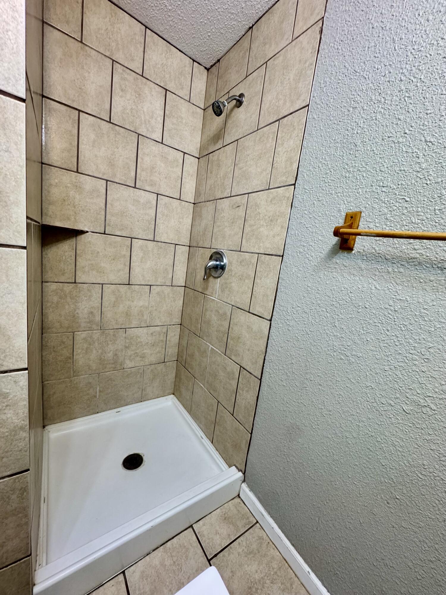 2421 22nd Street, Unit FRONT Lubbock, TX 79411 - Photo 13 of 17 a bathroom with a shower