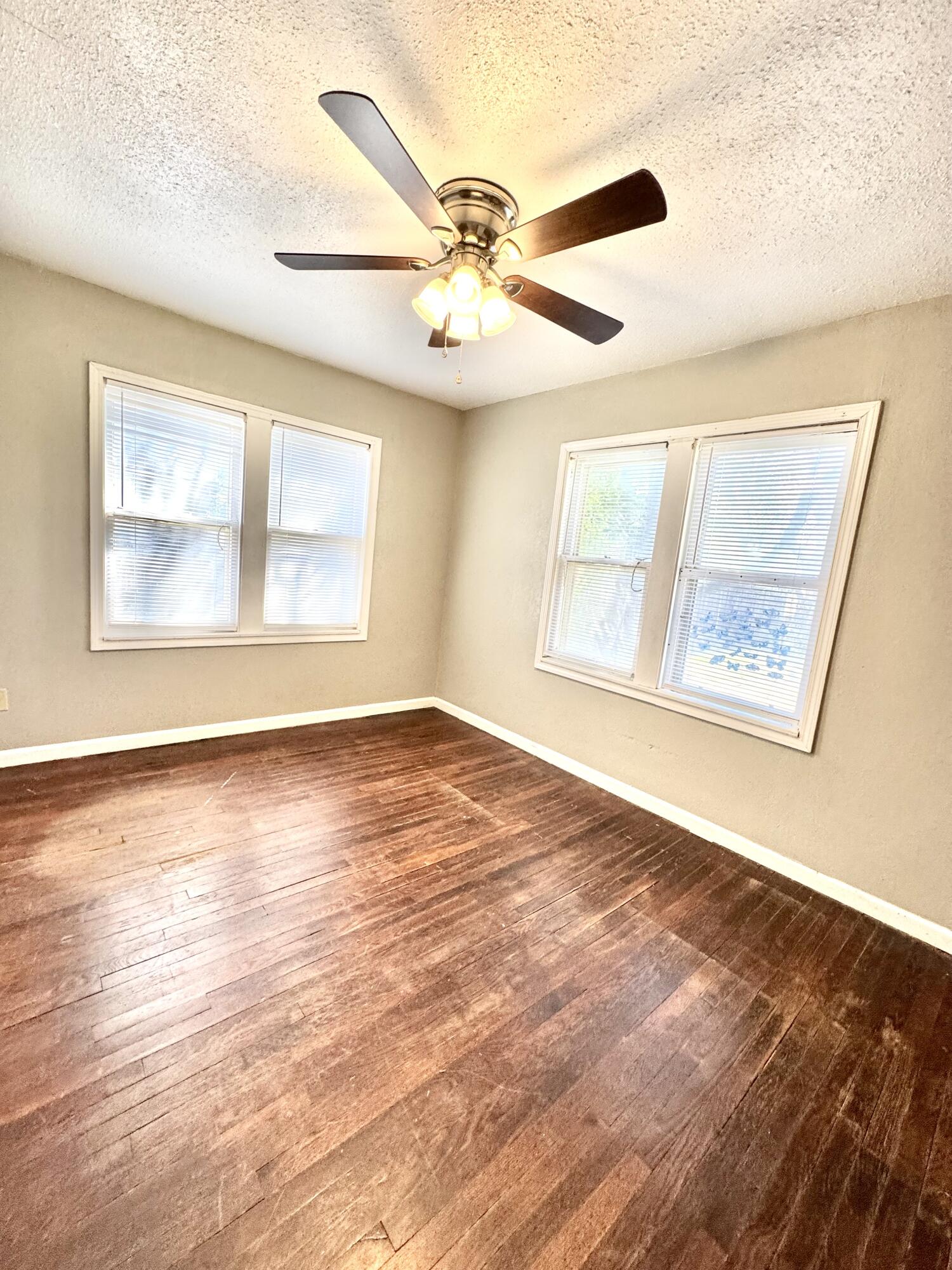 2421 22nd Street, Unit FRONT Lubbock, TX 79411 - Photo 16 of 17 a view of an empty room with wooden floor and a window