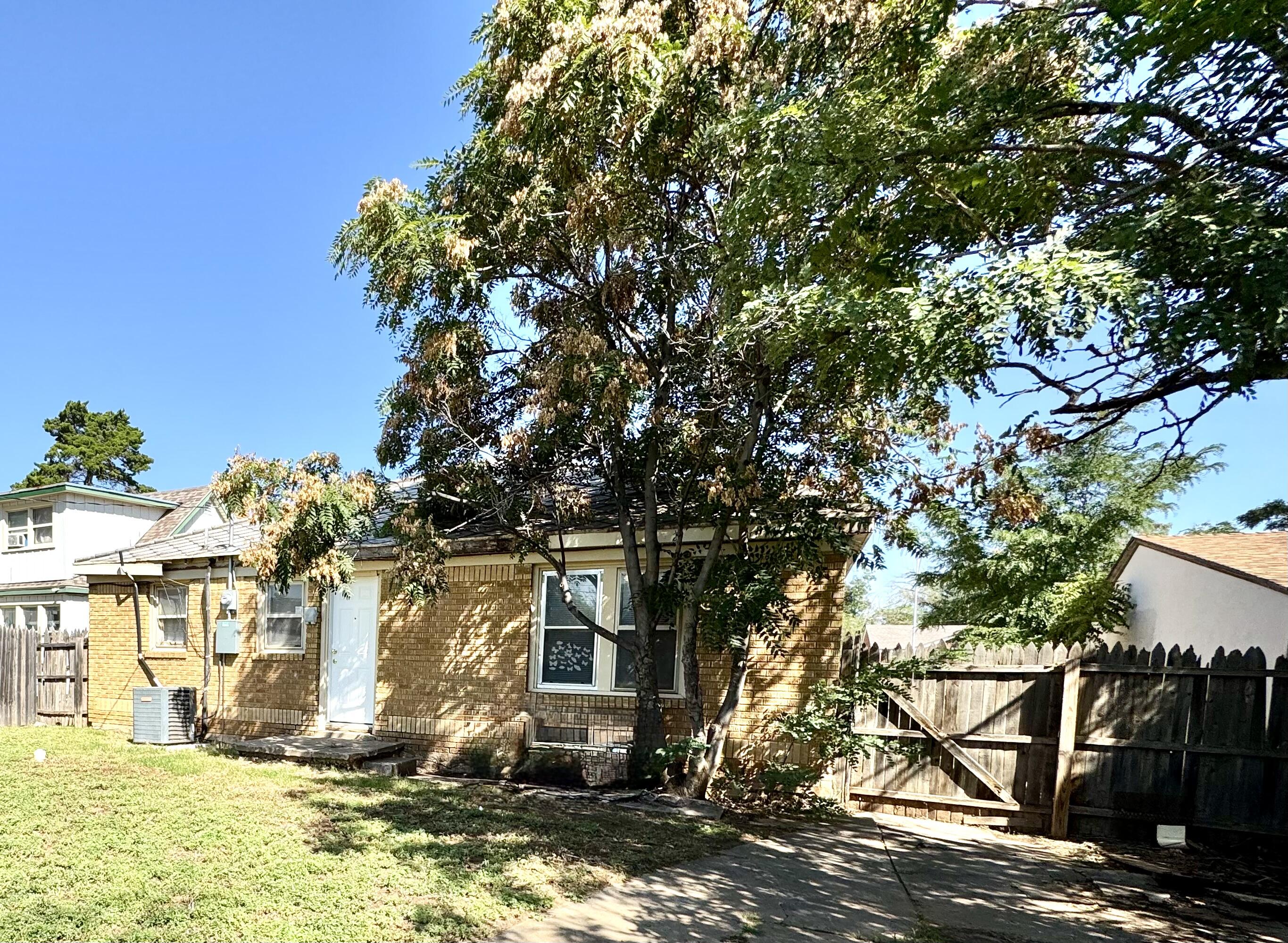 2421 22nd Street, Unit FRONT Lubbock, TX 79411 - Photo 17 of 17 a view of a house with a tree in front