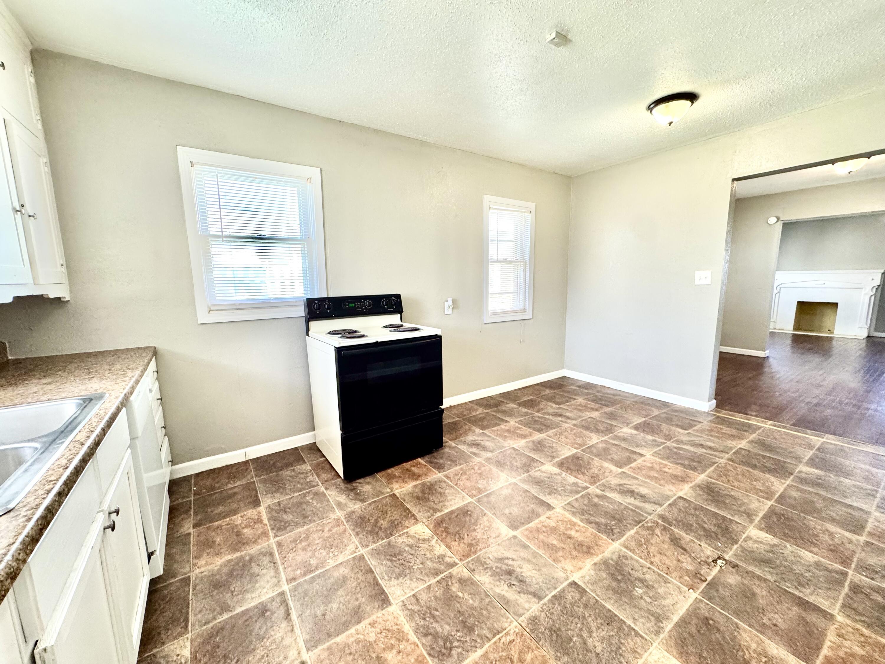 2421 22nd Street, Unit FRONT Lubbock, TX 79411 - Photo 10 of 17 a view of a kitchen with wooden cabinet and a window