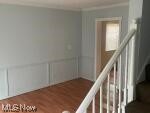 15321 Ridpath Avenue Cleveland, OH 44110 - Photo 3 of 10 Stairway featuring hardwood / wood-style flooring