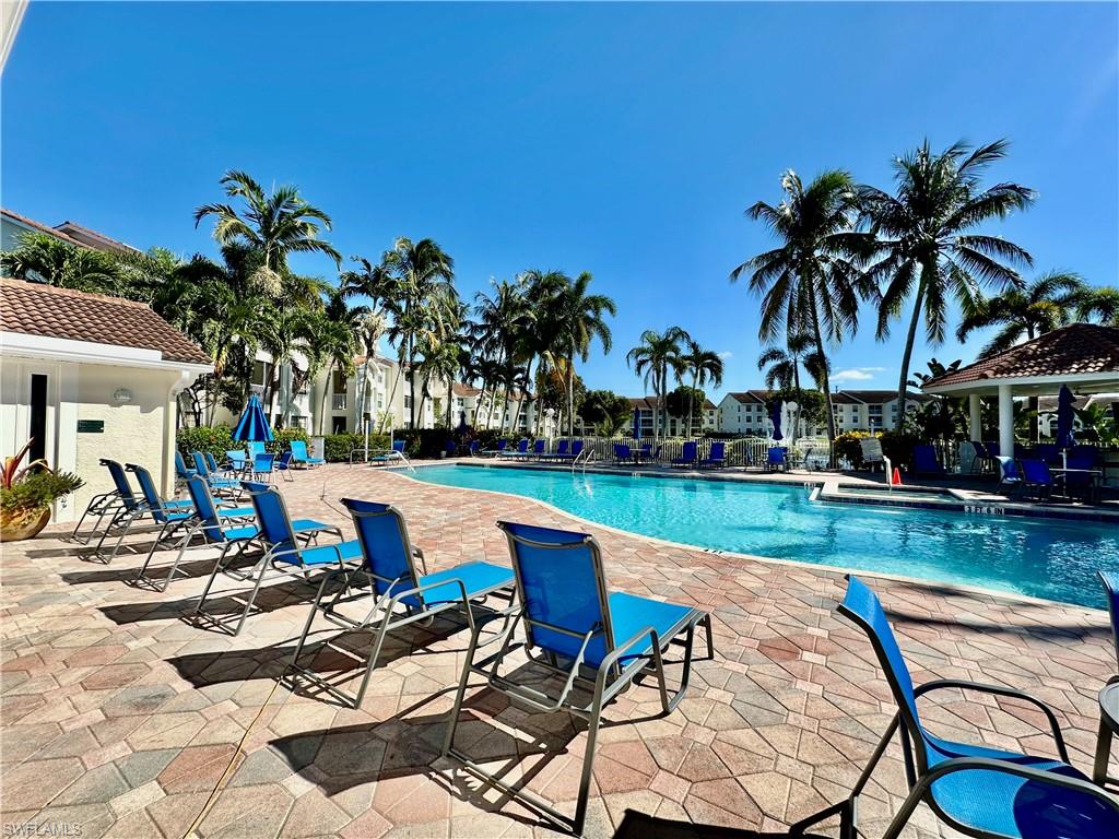 4700 St Croix Lane, Unit 335 Naples, FL 34109 - Photo 22 of 31 a view of swimming pool with seating area and garden