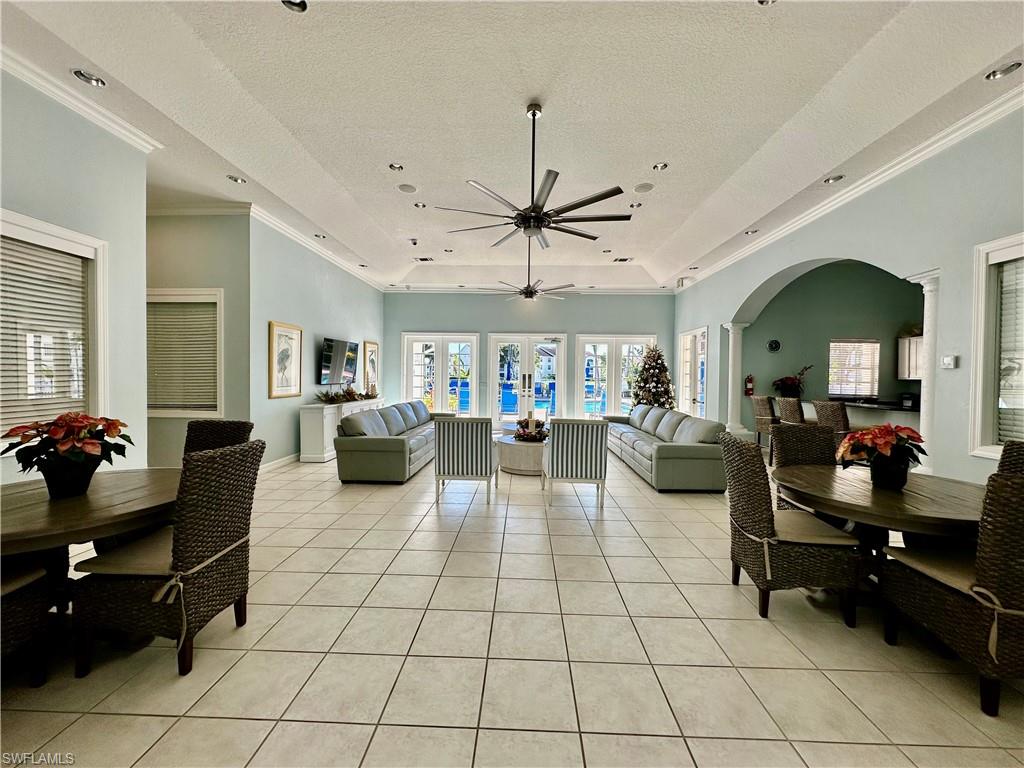 4700 St Croix Lane, Unit 335 Naples, FL 34109 - Photo 27 of 31 a living room with lots of furniture and a chandelier