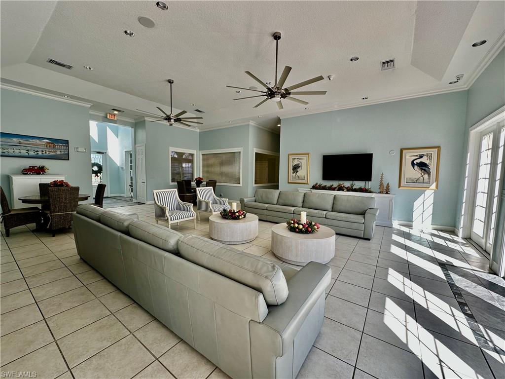 4700 St Croix Lane, Unit 335 Naples, FL 34109 - Photo 29 of 31 a living room with furniture and a flat screen tv