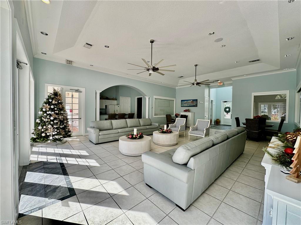 4700 St Croix Lane, Unit 335 Naples, FL 34109 - Photo 31 of 31 a living room with furniture a rug and a chandelier