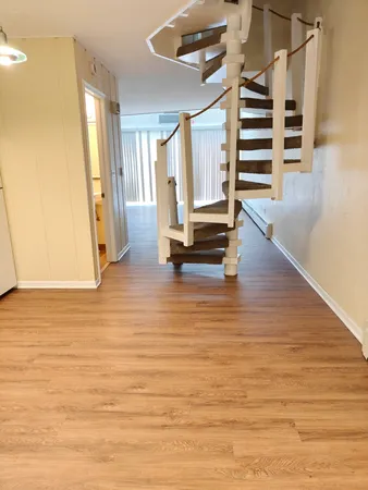 a view of an empty room with stairs and ventilation