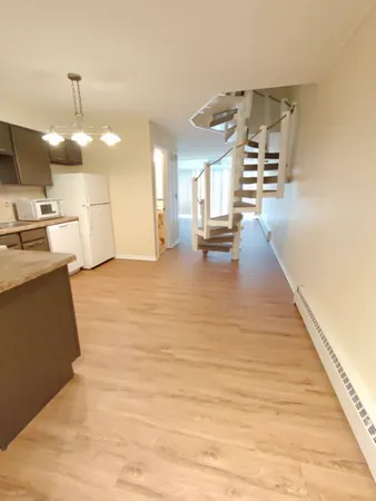 a view of kitchen and dining room with wooden floor