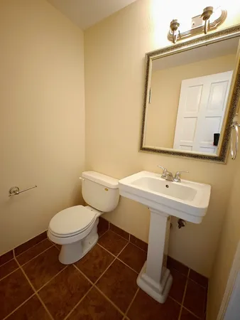 a bathroom with a sink toilet and mirror