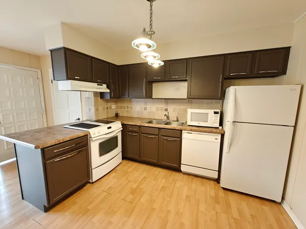 a kitchen with a stove a sink and a refrigerator