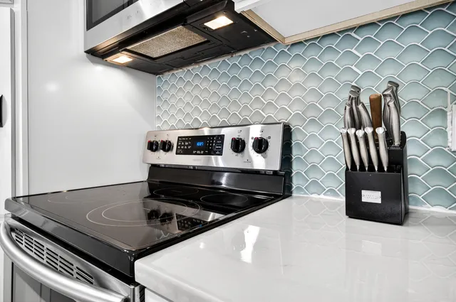 a view of a kitchen with kitchen island a counter top space a sink and wooden floor