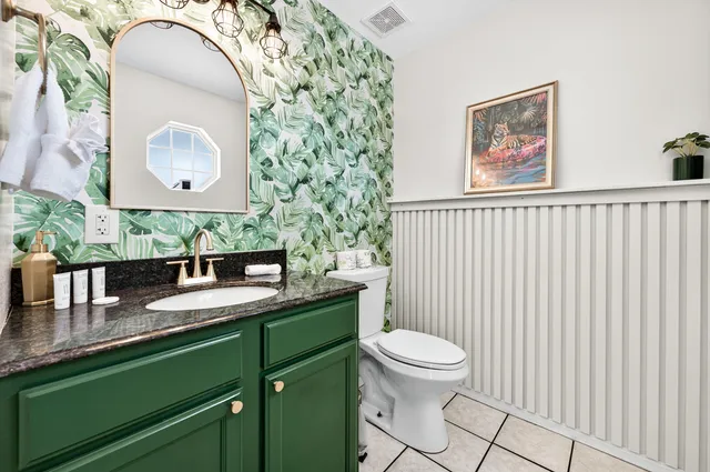 a bathroom with a granite countertop sink a mirror and vanity