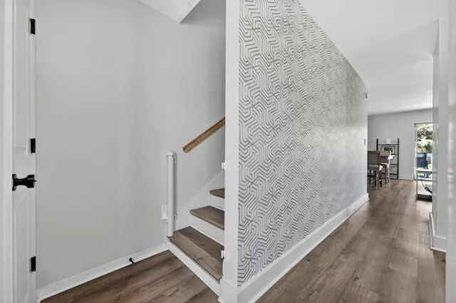 a view of a hallway view with wooden floor and staircase