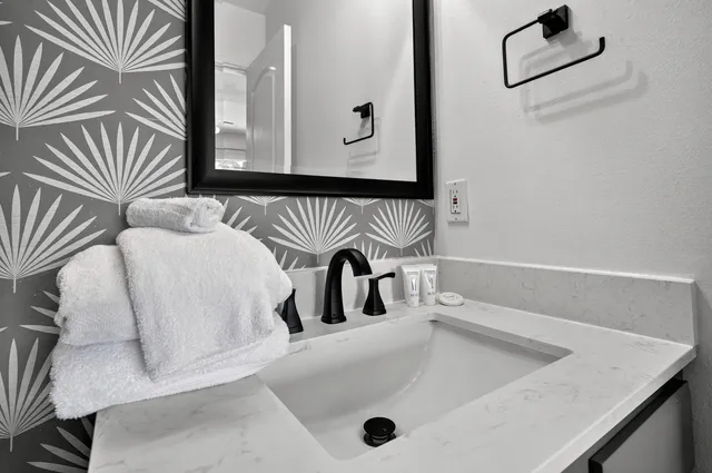 an aerial view of a house with a garden and lake view