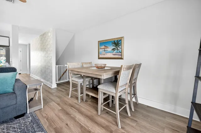a dining room with furniture and wooden floor