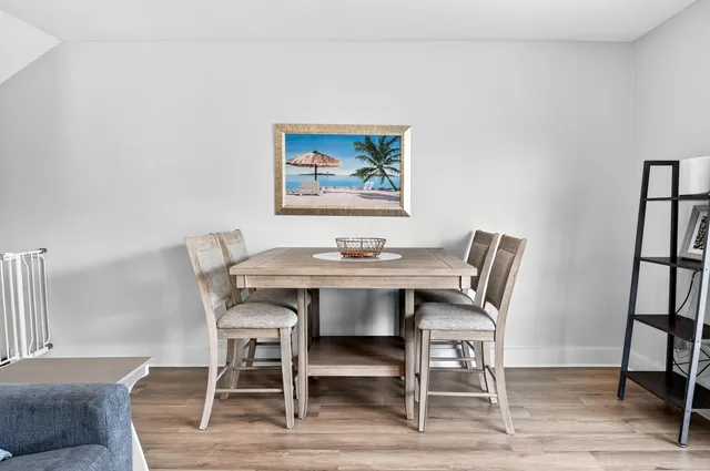 a view of a dining room with furniture wooden floor and a potted plant