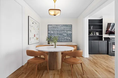 a dining room with a wooden table and chairs