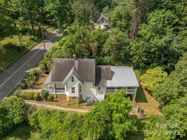 an aerial view of residential houses with yard
