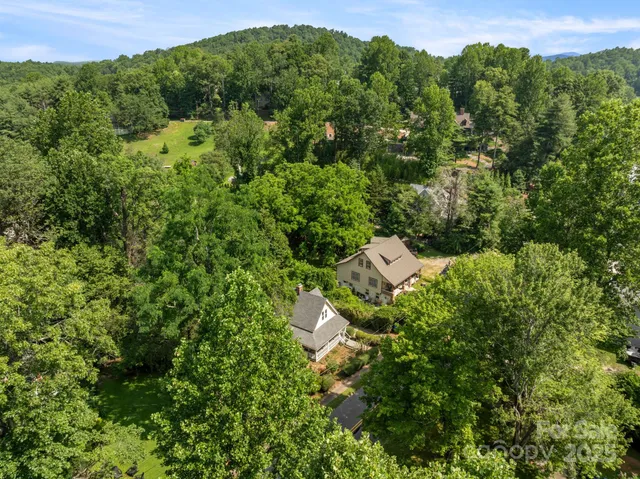 an aerial view of a house with a yard