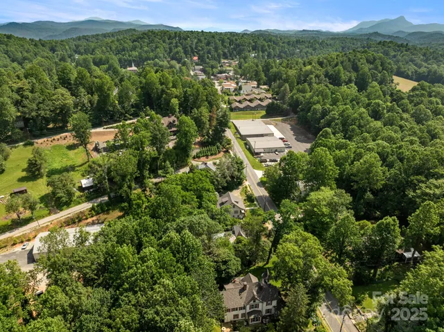 an aerial view of residential house with outdoor space and mountain view