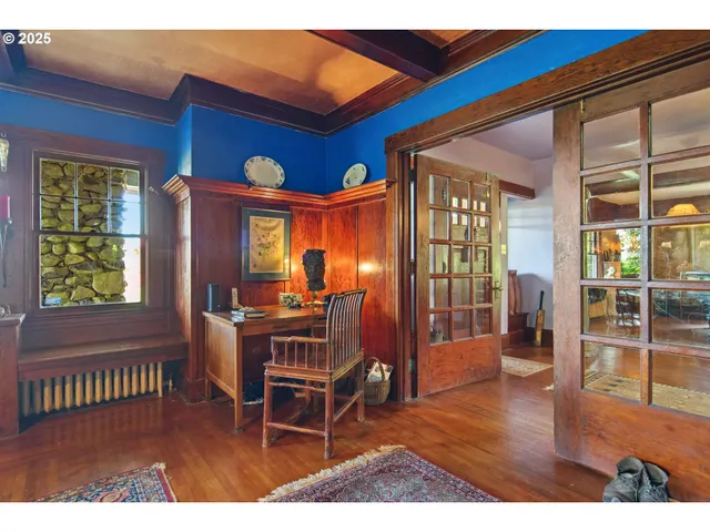 a dining room view with a wooden floor and windows