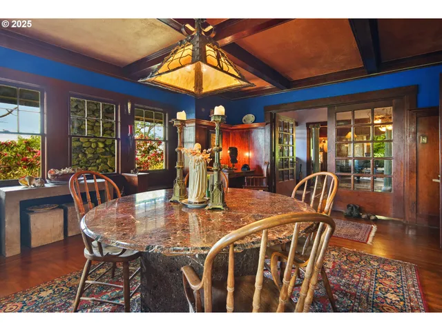 a dining room with furniture a chandelier and wooden floor