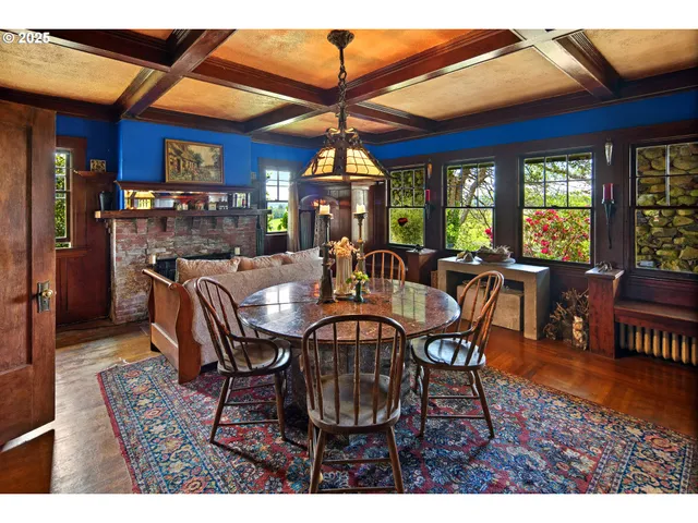 a dining room with furniture a chandelier and wooden floor