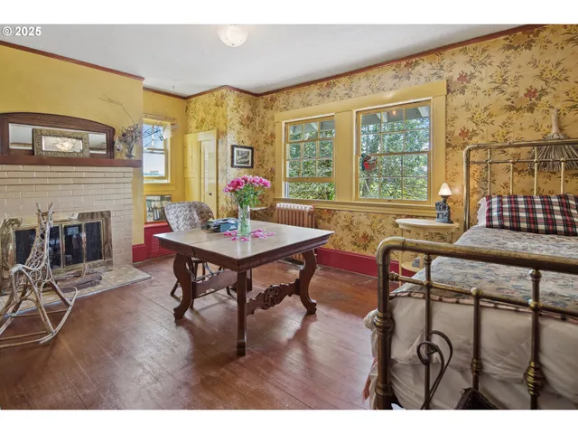 a living room with furniture a fireplace and a floor to ceiling window