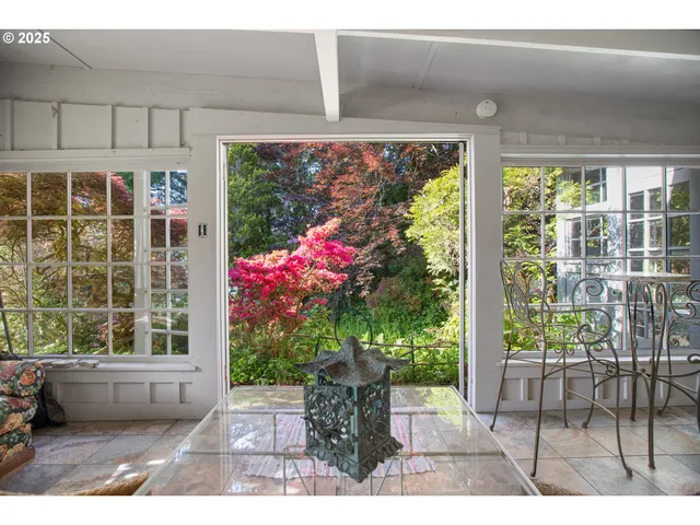 a view of a porch with chairs and potted plants