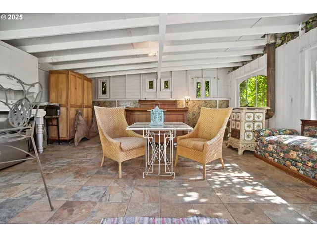 a view of a dining room with furniture and a window