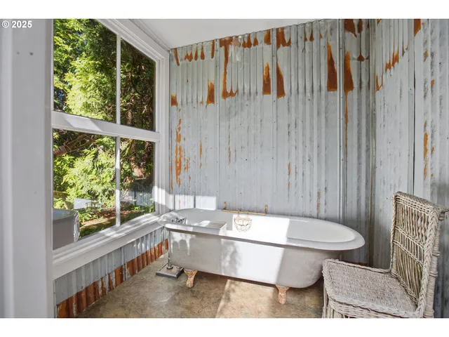 a bathroom with a sink toilet and a large window