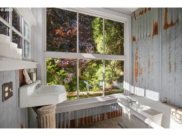 a kitchen view with a large window and front table
