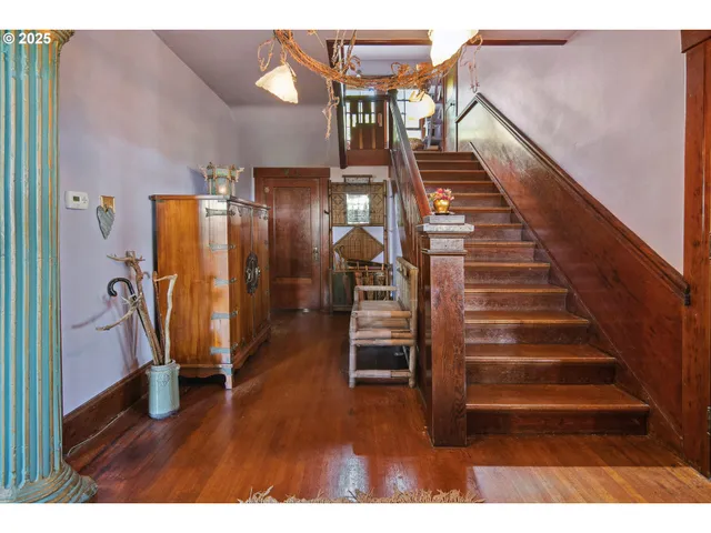 a view of entryway with stairs and wooden floor