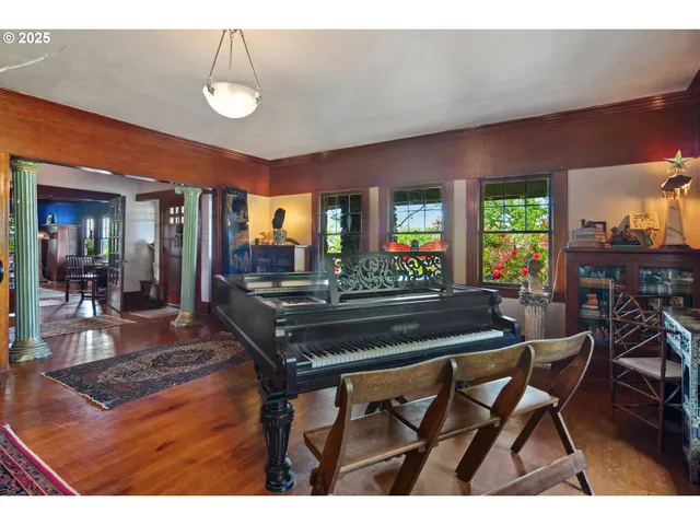 a living room with furniture a rug and a floor to ceiling window