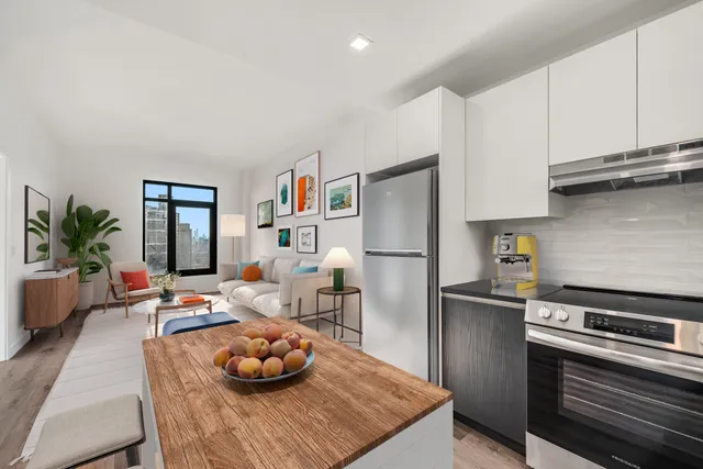 a kitchen with stainless steel appliances a refrigerator sink and cabinets