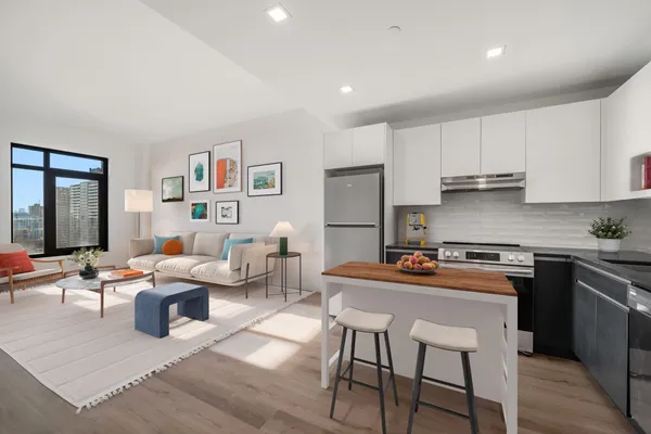 a kitchen with stainless steel appliances granite countertop a table and chairs