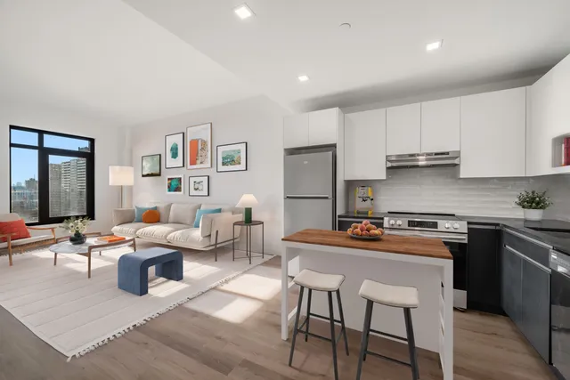 a kitchen with stainless steel appliances granite countertop a table and chairs