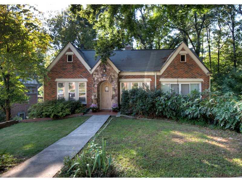 1900 Ridgewood Drive Northeast Atlanta, GA 30307 - Photo 1 of 1 a front view of a house with a yard and garage
