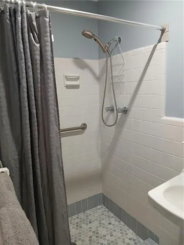 a bathroom with a glass shower door