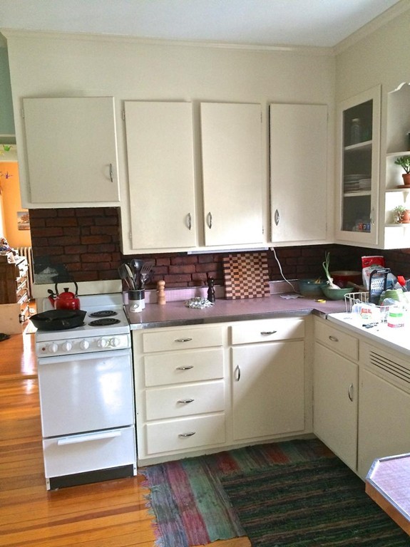 a kitchen with granite countertop a sink and a stove