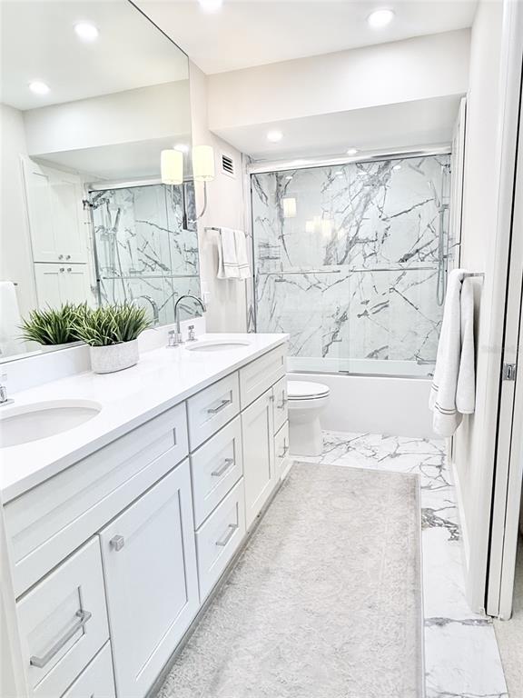1050 Longboat Club Road, Unit 803 Longboat Key, FL 34228 - Photo 24 of 39 a spacious bathroom with a double vanity sink a mirror a