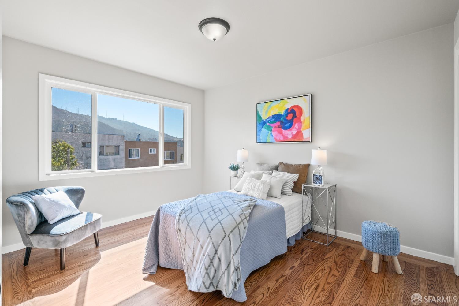 849 Hillside Boulevard Daly City, CA 94014 - Photo 11 of 17 a bedroom with a bed and wooden floor