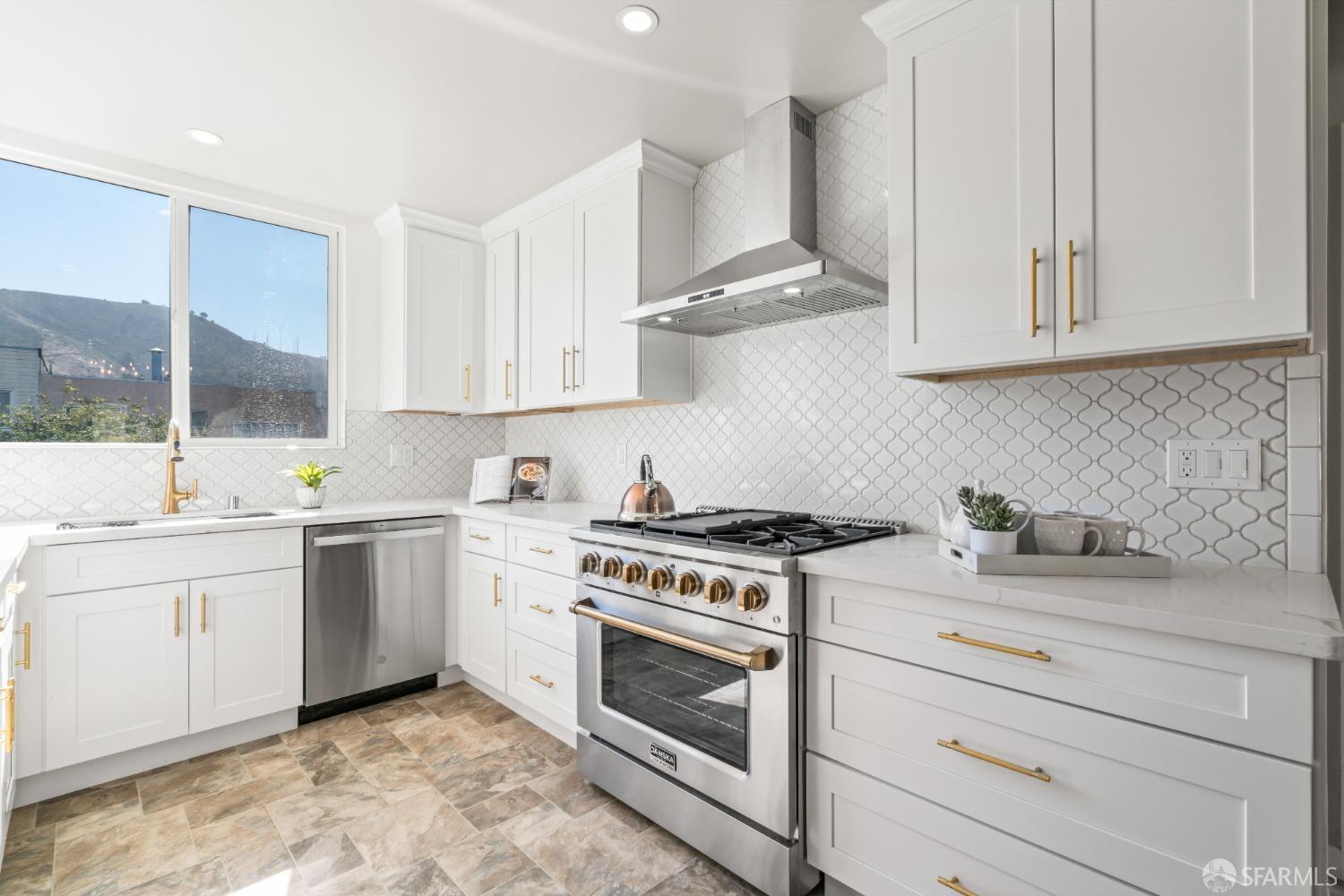 849 Hillside Boulevard Daly City, CA 94014 - Photo 2 of 17 a kitchen with granite countertop white cabinets and white appliances