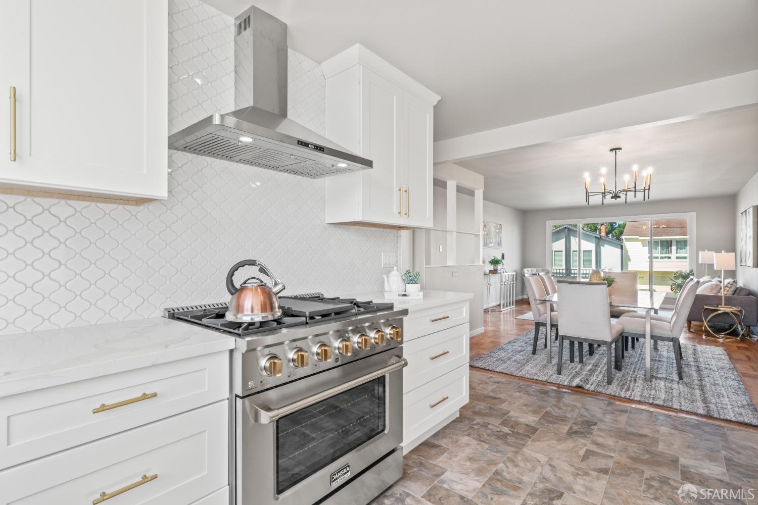 849 Hillside Boulevard Daly City, CA 94014 - Photo 3 of 17 a kitchen with stainless steel appliances granite countertop a sink a stove and a wooden floors