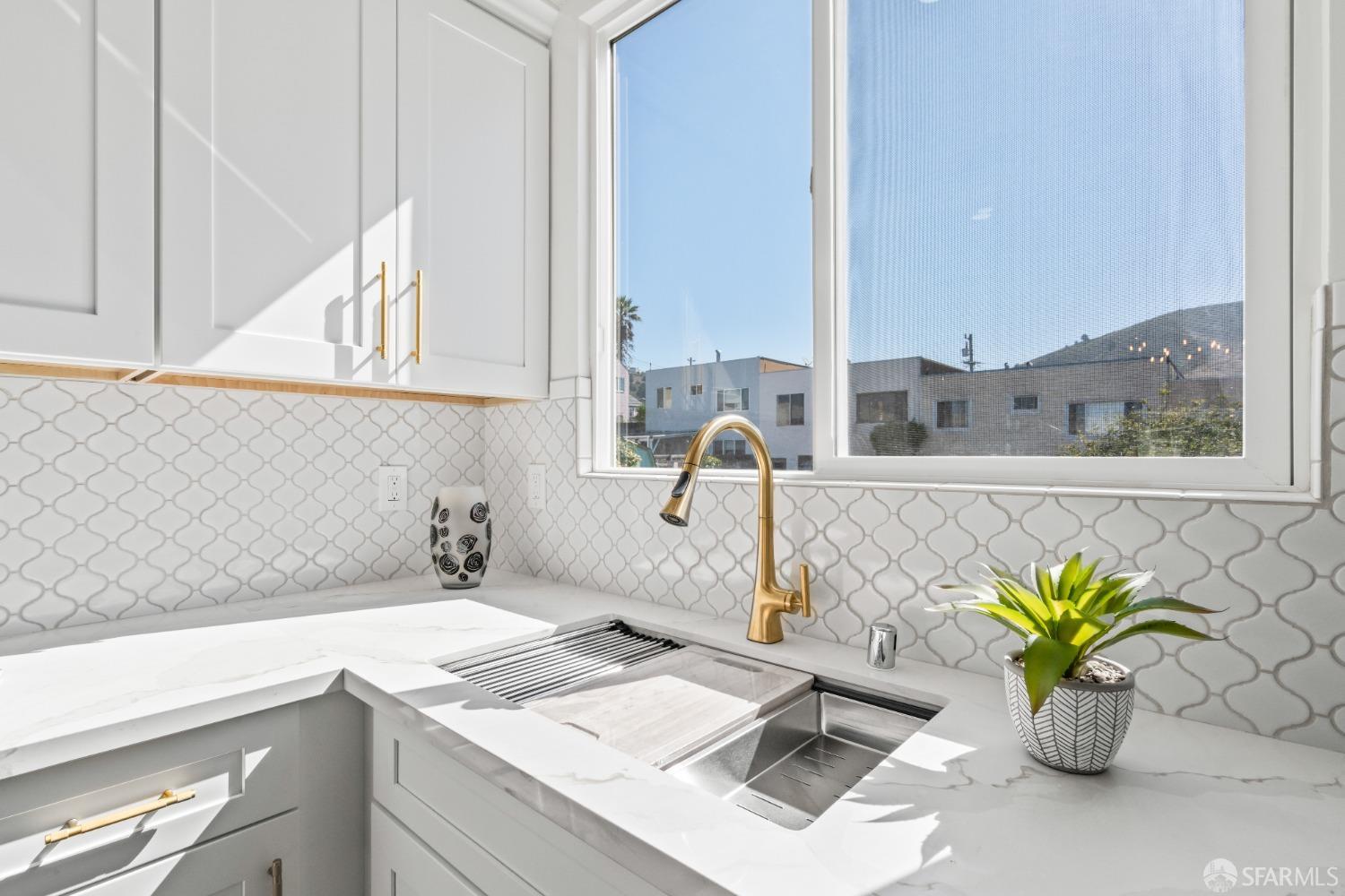 849 Hillside Boulevard Daly City, CA 94014 - Photo 4 of 17 a bathroom with a granite countertop sink and a potted plant