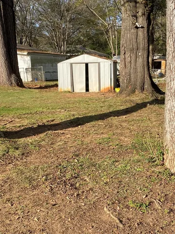 a view of a wooden house with a yard