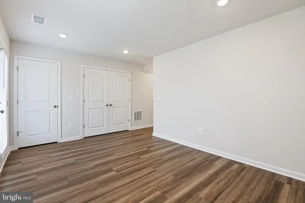 a kitchen with granite countertop a refrigerator a sink a stove and cabinets