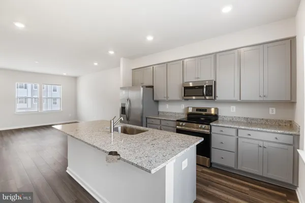 a kitchen with granite countertop a stove and a sink