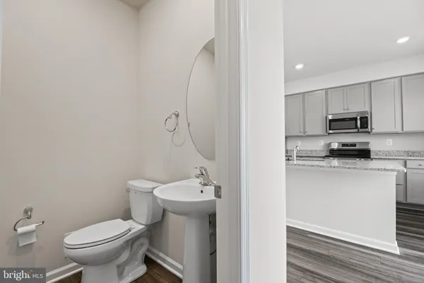 a bathroom with a sink a toilet and mirror