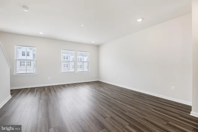 a view of a kitchen with wooden floor and a sink