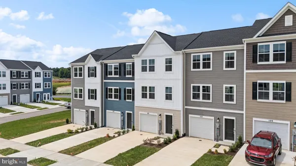 a front view of a residential apartment building with a yard